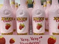 Closeup of pink bottles with xuxu cream strawberry liqueur in shelf of german supermarket