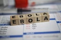 Closeup of word ebola on laboratory requisition slip with syringe and vial