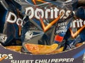 View on bags with logo lettering of doritos tortilla chips in shelf of german supermarket