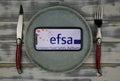 View on mobile phone screen on plate with logo lettering of european food safety association
