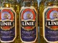 Closeup of bottles with lysholm linie aquavit logo lettering in shelf of german supermarket