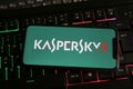 Closeup of mobile phone with logo lettering of kaspersky anti virus computer security software on keyboard Royalty Free Stock Photo