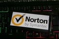 Closeup of mobile phone with logo lettering of norton symantec anti virus computer security software on keyboard