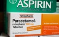 Closeup of paracetamol and aspirin painkilller pills packages on wood table