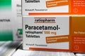 Closeup of paracetamol painkilller pills packages on wood table focus on center of word paracetamol