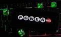 Closeup of smartphone with logo letterin of american powerball powerplay lottery game on computer keyboard