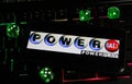 Closeup of smartphone with logo letterin of american powerball powerplay lottery game on computer keyboard