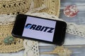 Closeup of smartphone with logo lettering of orbitz travel agency with sun hat and shells on wood table Royalty Free Stock Photo