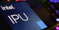 Closeup of smartphone screen with logo lettering of Intel IPU on computer keyboard Royalty Free Stock Photo