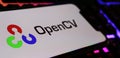 Closeup of smartphone screen with logo lettering of OpenCV library on computer keyboard