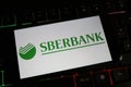 View on mobile phone screen on computer keyboard with logo of russian sberbank