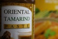 Close up of bottle label thai oriental tamarind paste, yellow Curry box background