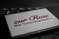 Close up of mobile phone screen on computer keyboard with logo lettering of german online mail-order pharmacy zur Rose Royalty Free Stock Photo