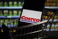 Close up of mobile phone screen in shopping cart modell with logo lettering of us american Costco wholesale supermarket chain