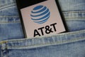 Close up of smartphone screen in blue jeans pocket with logo lettering of american mobile phone provider AT and T wireless