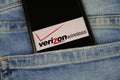 Close up of smartphone screen in blue jeans pocket with logo lettering of american mobile phone provider Verizon wireless