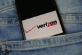 Close up of smartphone screen in blue jeans pocket with logo lettering of american mobile phone provider Verizon wireless