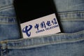 Close up of smartphone screen in blue jeans pocket with logo lettering of chinese mobile phone provider China Telecom