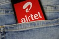 Close up of smartphone screen in blue jeans pocket with logo lettering of indian mobile phone provider bharti Airtel