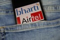 Close up of smartphone screen in blue jeans pocket with logo lettering of indian mobile phone provider bharti Airtel