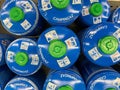 Closeup of blue camping campingaz butane propane gas cylinders in shelf of german supermarket