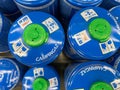 Closeup of blue camping campingaz butane propane gas cylinders in shelf of german supermarket