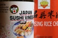 Closeup of japanese miyako rice sushi vinegar bottle label, blurred chinese wine background