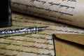 Macro closeup of retro ink pen, old vintage paper with handwritten text Royalty Free Stock Photo