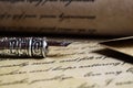 Macro closeup of retro ink pen, old vintage paper with handwritten text Royalty Free Stock Photo