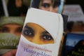 View on collection of international books with stories about veiled muslim women fates