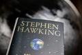 View on isolated book cover of Stephen Hawking with blurred world globe background Royalty Free Stock Photo