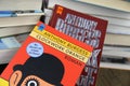 View on isolated book covers of Anthony Burgess clockwork orange with pile of books background