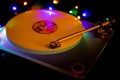 Close up of isolated vintage retro record player with white vinyl lp. Shiny colorful bokeh background