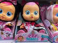 Close up of IMC toys cry babies dolls in shelf of german supermarket focus on face of central doll