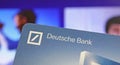 Closeup of banking card with logo lettering of deutsche bank, blurred website background