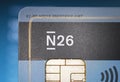 Closeup of N26 direct bank debit card, blurred website background