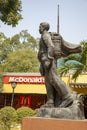 Viet Cong soldier statue and McDonalds sign in Ho Chi Minh City Vietnam