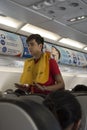 Vietjet Air steward presents the security protocol before take off at Saigon airport, Ho Chi Minh City, Vietnam Royalty Free Stock Photo