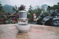 Vietnam coffee style, Drip coffee, Dropping water on Ground coffee in stainless filter with wooden table background. top view and