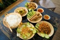 Vietnam family home cook set for four person: cooked rice, vegetable soup and fried fishes, fried onions with chicken, cucumber Royalty Free Stock Photo