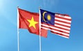 Vietnam flag and Malaysia flag on cloudy sky Royalty Free Stock Photo