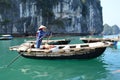 Lady rowing a boat amongst the limestone karsts, Vung Vieng, Halong Bay Vietnam Royalty Free Stock Photo