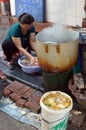 Lady preparing poultry ready for the boiling hot pot, Hanoi Vietnam 