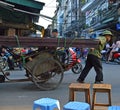 Man pulling heavy rickshaw full of metal Hanoi Vietnam