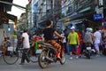 Evening `rush hour` of cyclists mopeds and pedestrians in Hanoi Vietnam Royalty Free Stock Photo