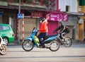 Vietnam, Hanoi. Young woman rides on motorbike