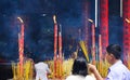 HO CHI MINH CITY, VIETNAM - JANUARY 5. 2015: Buddhist believers light incense sticks at shrine in chinese buddhist temple