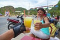 Vietnam. A motorcycle trip, a young couple drinks chilled juice. Cane-juice from sugar cane for tourists