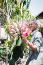 Vietnam, Nha trang, March 2018. Lotus pond. Asian man holds in his hand a bouquet of lotus flowers. Editorial photo