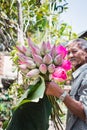 Vietnam, Nha trang, March 2018. Lotus pond. Asian man holds in his hand a bouquet of lotus flowers. Editorial photo